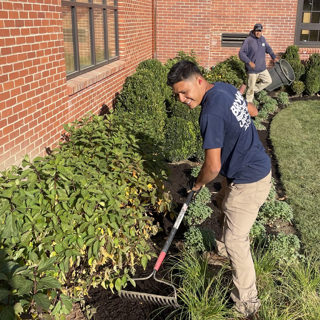 Brooks crew member mulching planting beds